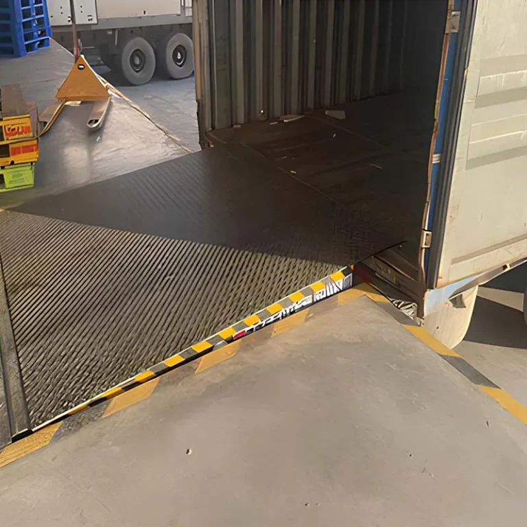 Loading dock leveler installed at factory truck bays for seamless truck-to-dock access